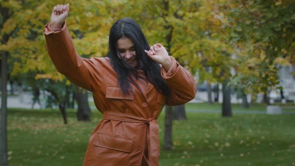 Attractive Energetic Happy Young Woman Actively Dancing Incendiary Moving Outdoors in Autumn Park