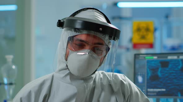 Close Up of Tired Chemist Man Doctor in Coverall Working in Lab