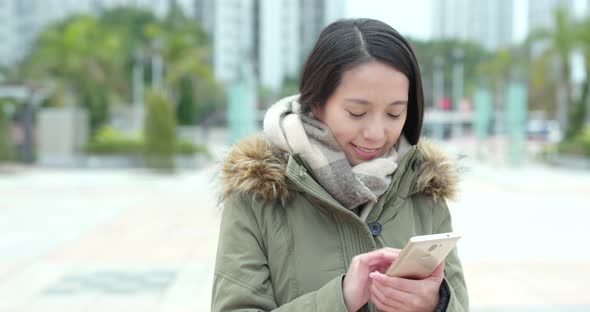 Woman use of mobile phone in outdoor park