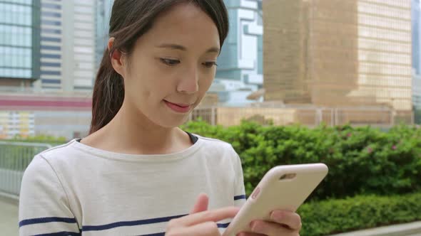 Woman use of cellphone at central of Hong Kong