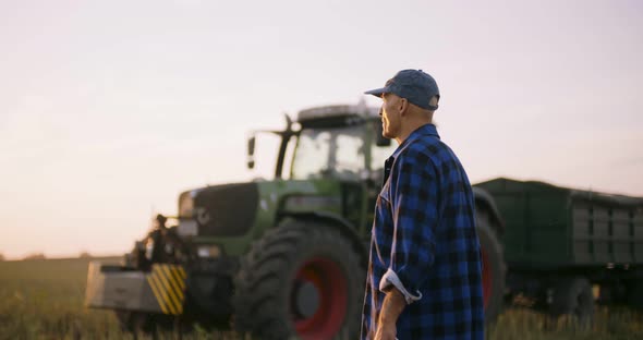 Farmer Using Digital Tablet While Examining Field