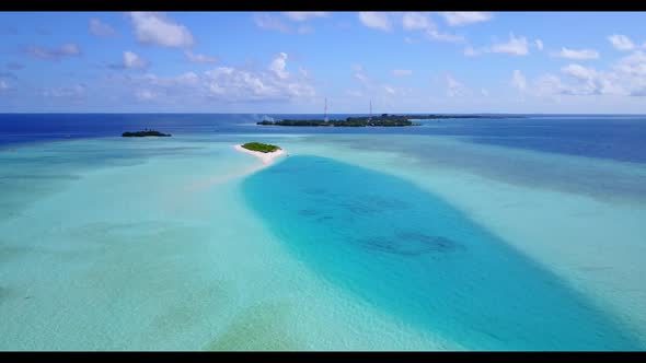 Aerial view landscape of idyllic tourist beach trip by clear sea with white sandy background of a da