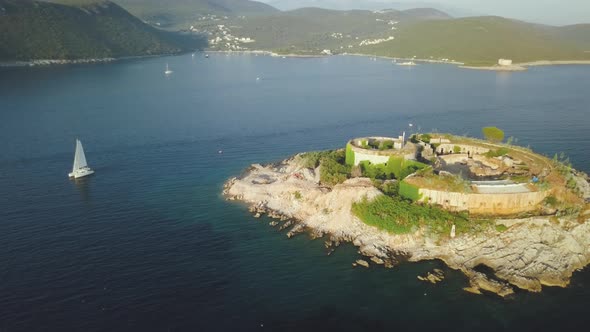 Aerial view of  island with an abandoned fortress in the middle of the sea in Montenegro.