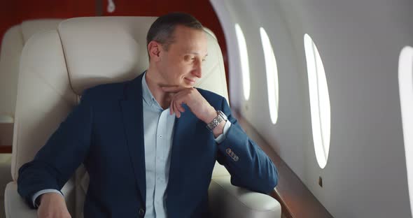 Businessman in Suit on Business Trip By First Class Flight