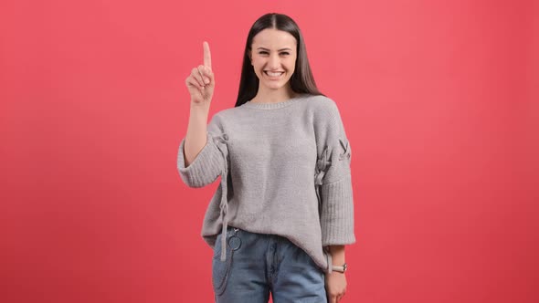 Young Woman Showing and Raising a Finger As a Sign of the Best Idea