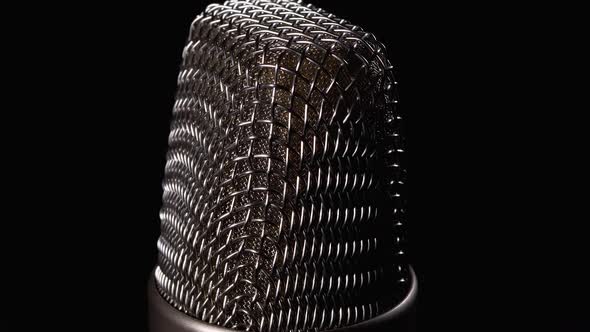 Studio Condenser Microphone Rotates on Black Background