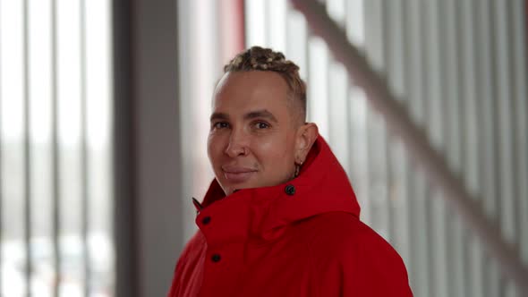 Closeup Portrait of a Handsome Gay Man Walking in Winter in a Red Jacket Through the Streets of the