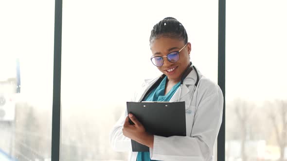 African American Young Medical Worker with Notepad