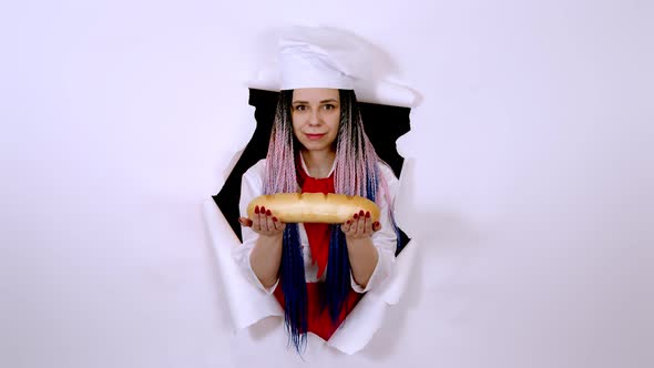 Young Woman Dressed As Chef Holding White Bread