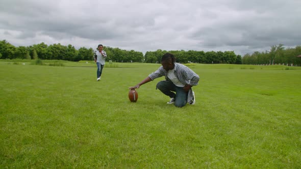 Cheerful Little American Football Player Kicking Free Kick on Pitch