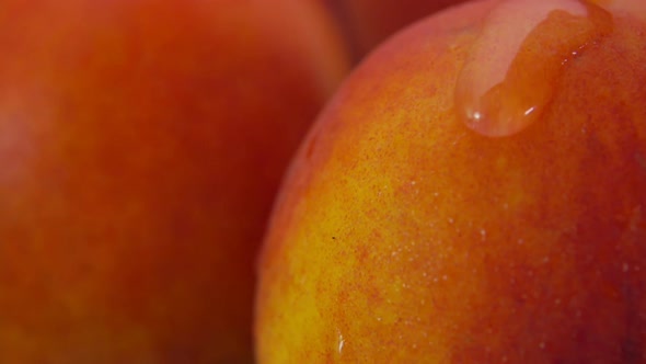 Super Closeup of a Drop of Water Flowing Down the Surface of a Ripe Nectarine