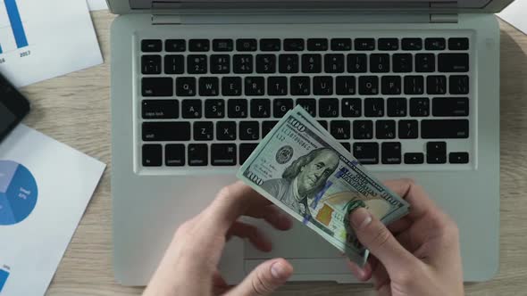 Businessman's Hands Counting Dollars, Confidence in Future, Importance of Money