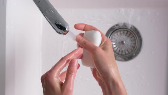 Woman Washes Hands with Soap