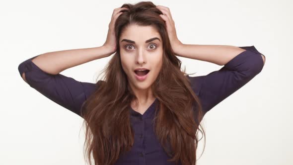 Beautiful Caucasian Female in Dark Blue Shirt and with Long Brown Hair Standing on White Background