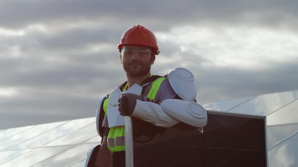 Male Technician with Photovoltaic Panel on Cloudy Day