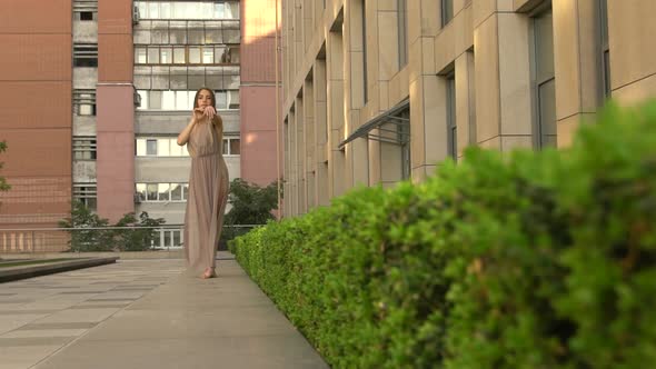 Beautiful Young Girl Dancing Performing Contemporary on the Street of a Modern City. Slow Motion.