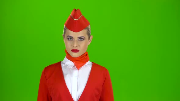 Stewardess Looks Up and Smiles. Green Screen