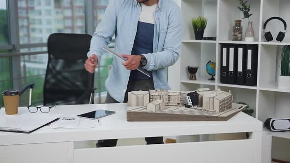 Professional Bearded 30-Aged Architect Working with Mock-up of Future Building