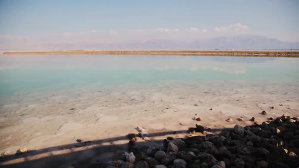 View of the sea beach at daytime. Mountains are far away. Dead sea shore near Ein Bokek, Israel