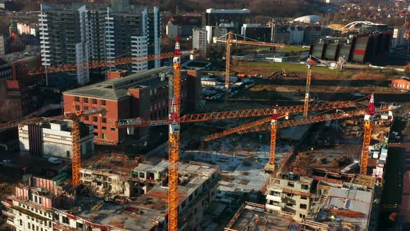 Aerial View of a Construction Site with Cranes and Heavy Machinery alt