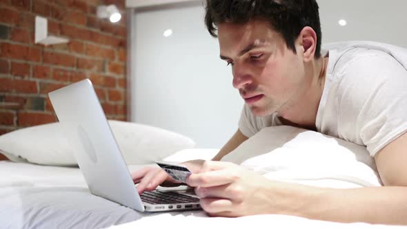 Online Shopping By Man in Bed Payment By Credit Card