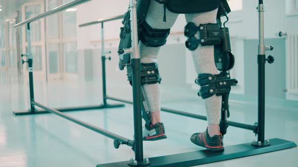 A Patient in Exoskeleton is Learning to Walk in the Hospital