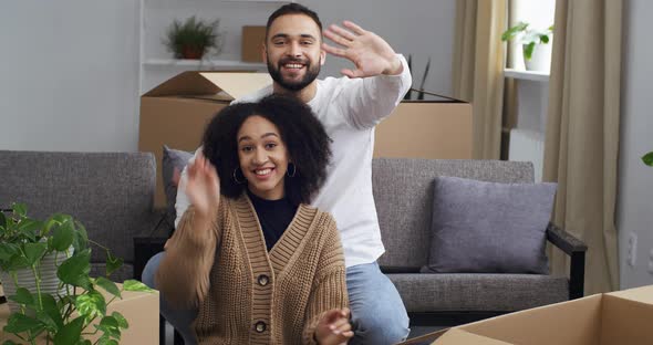 Happy Interracial Couple Afro American Woman and Caucasian Man Homeowners Sitting Together on Couch