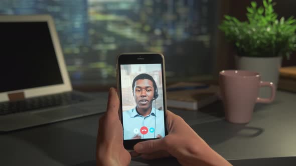 Video Call to the Black Business Partner on Smartphone