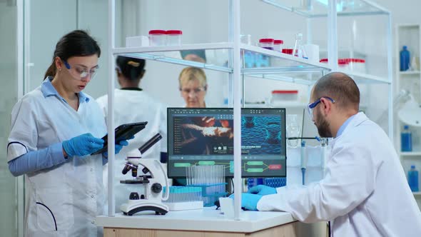 Scientist Nurse Taking Notes on Tablet in Laboratory