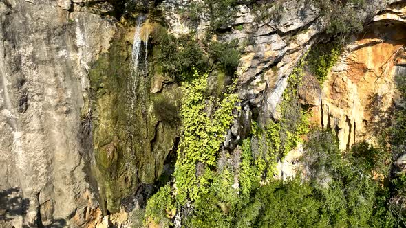 A small waterfall in the mountains aerial view 4 K