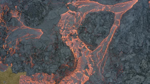 Aerial View Of A Boiling Lava Lake Flowing Down The Volcano With Volcanic Smoke Covering The Sky.