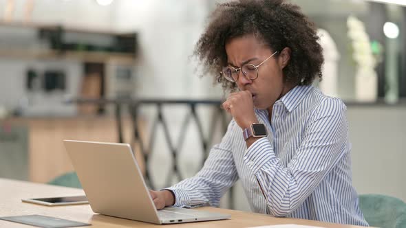 Sick African Businesswoman with Laptop Coughing in Office 