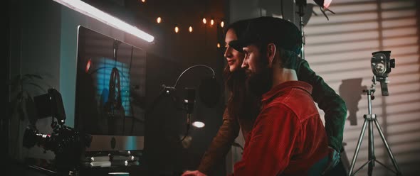 The filmmaker and the actress looking at the movie clips