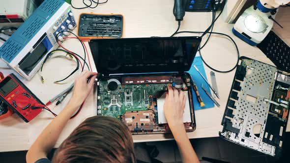 Top View of a Laptop Getting Repaired By an Engineer