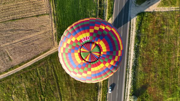 Hot air balloons fly over the mountainous landscape of Cappadocia, Turkey.