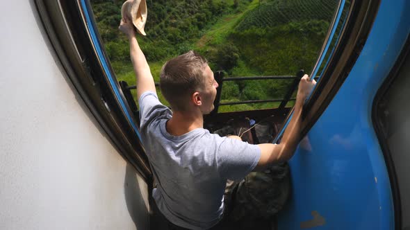 Young Male Traveler Rides a Train on Vacation in Sri Lanka