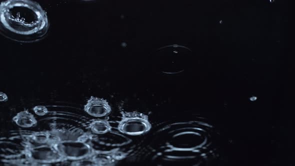 4K 30fps, Rain drops rippling in a puddle, Slow Motion