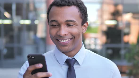 Outdoor African Businessman Using Smartphone
