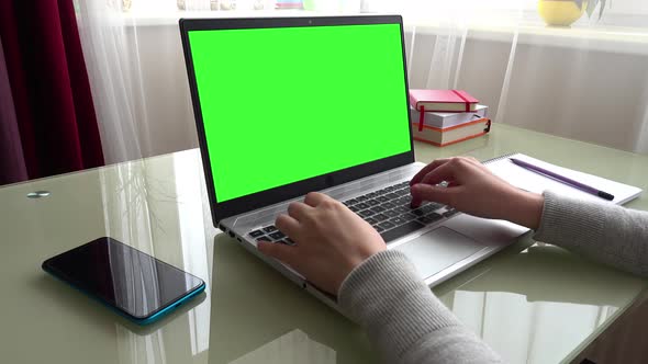 The girl working at home office hands on keyboard.