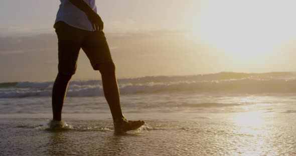 Man walking on the beach during sunset 4k