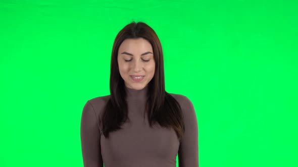 Attractive Girl Smiling While Looking at Camera. Green Screen