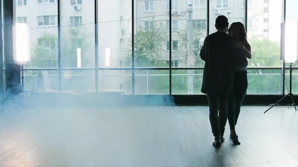 A Couple Starting To Dance While the Smokes Begins To Appear