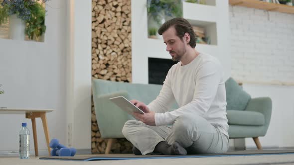 Young Man Using Tablet While Standing in Kitchen