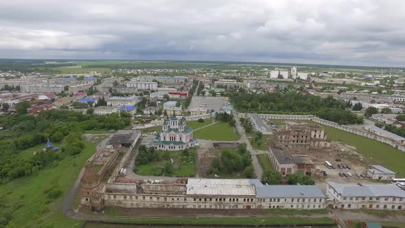 Aerial view monastery surrounded by a brick wall on the edge of the city 15