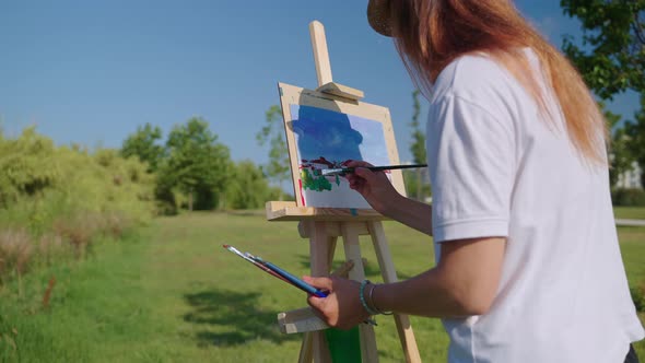 Painting From Nature Woman Artist is Drawing Outdoors in Summer