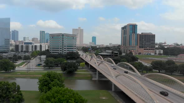 A slowing aerial drone shot showing the Fort Worth, Texas skyline and 7th street bridge.