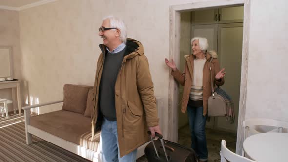 Mature Caucasian Husband and Wife Admiring Hotel Room