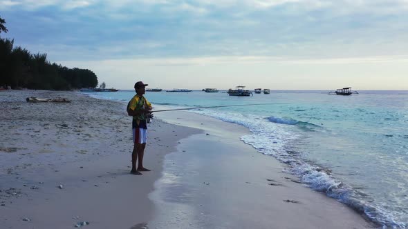 Male model fisherman on beautiful sea view beach vacation by blue ocean with white sand background o