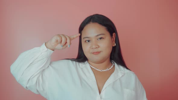 Asian Plus Size Woman in White Shirt Shows Stupid