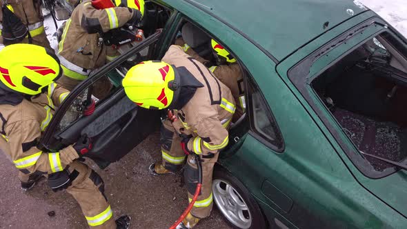 Firefighter Cutting Car Doors with Hydraulic Cutter. Car Accident
